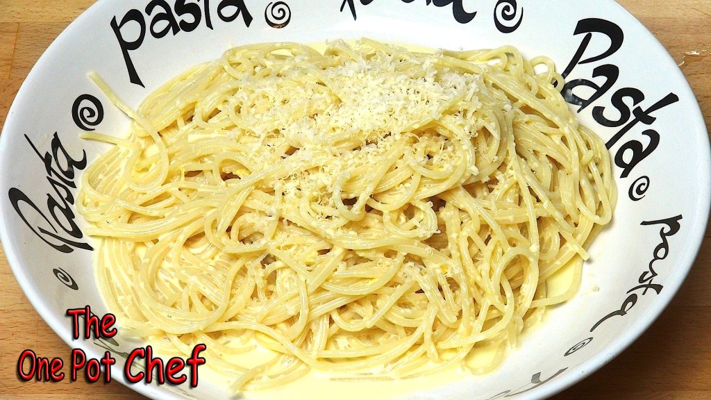 A bowl of creamy pasta topped with grated cheese, with the word 'pasta' featured in a playful design around the edge of the bowl.