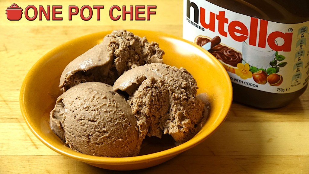 A bowl of chocolate ice cream with a scoop and a spoon, next to a jar of Nutella.