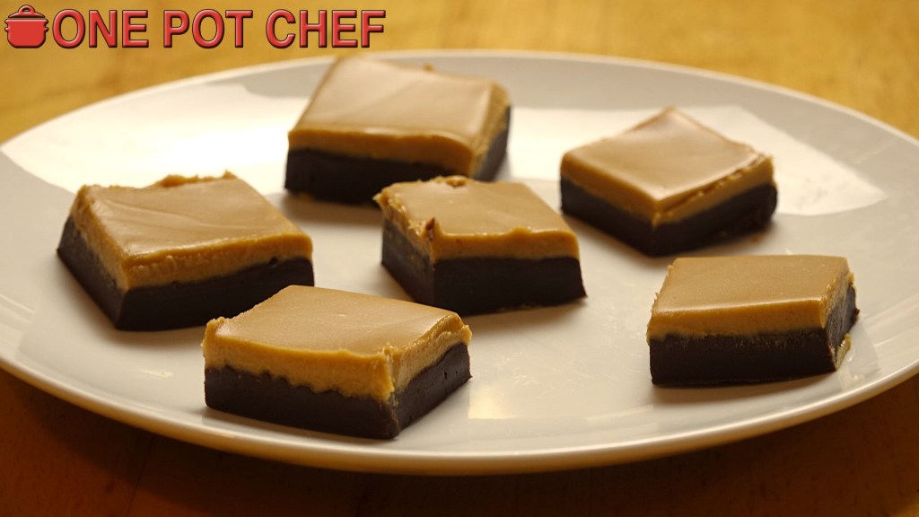 A plate of six chocolate and caramel squares, arranged neatly, on a wooden surface.